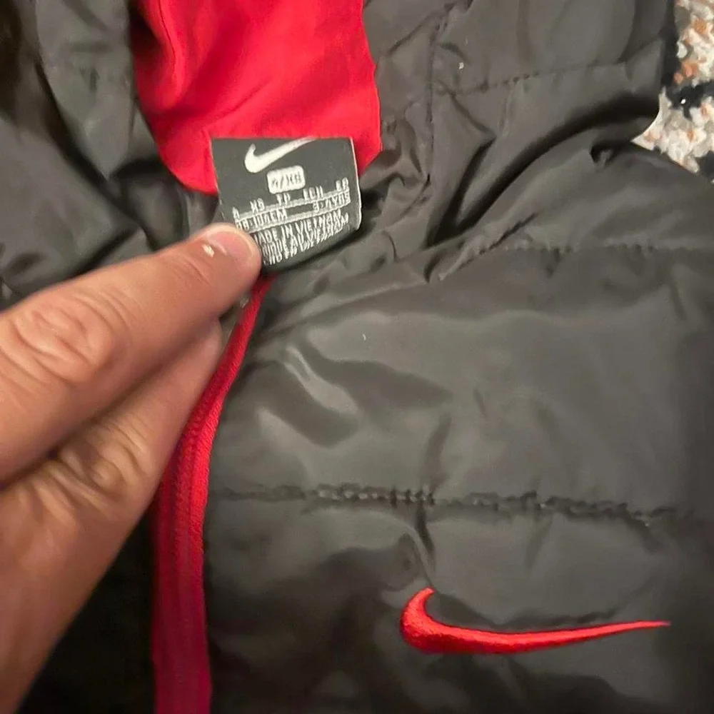 Nike black puffer jacket with red accents, size XS